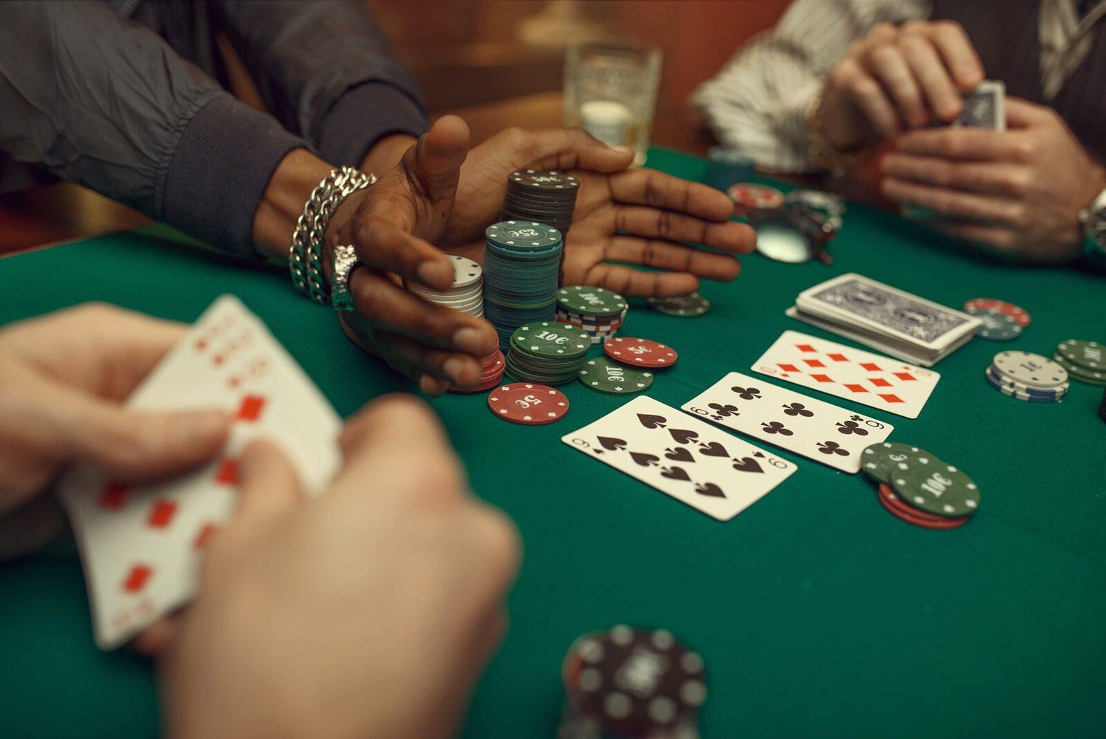 Friends playing a home cash game with euro-denomination poker chips