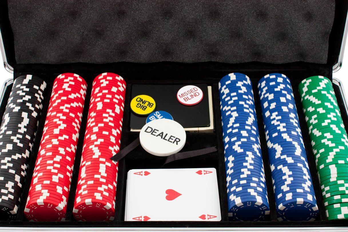 An open poker chip case with chips sorted by colour