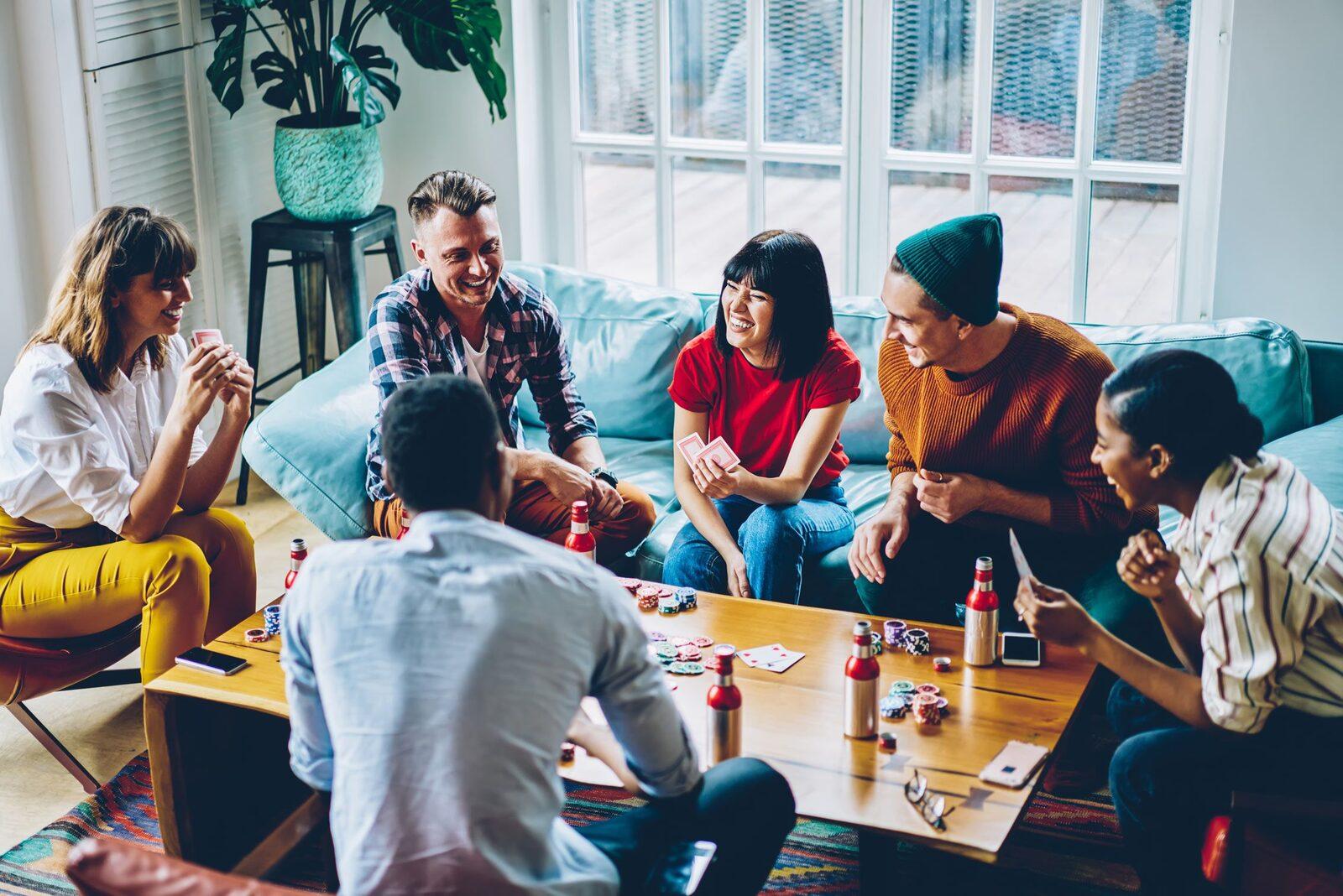 Friends gathered around a table playing a relaxed home poker game