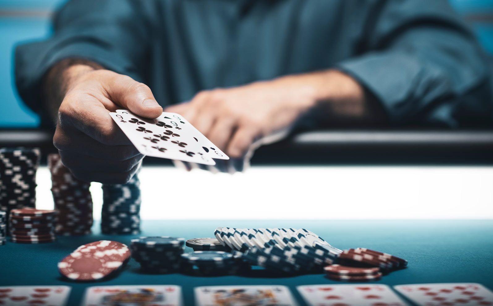 A player dealing cards across a poker table