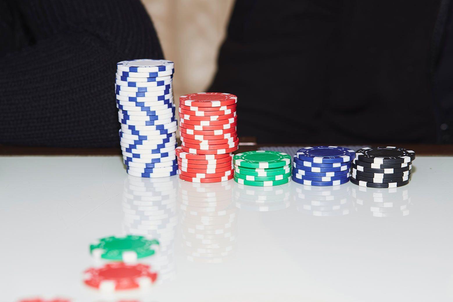 Stacks of poker chips sorted by colour and value on a table